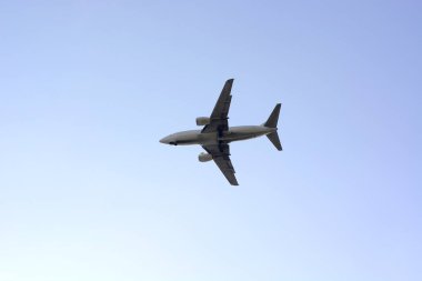 Gün batımında mavi bulutsuz gökyüzünde uçak.