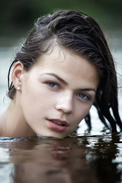 Young brunette in water — Stock Photo, Image