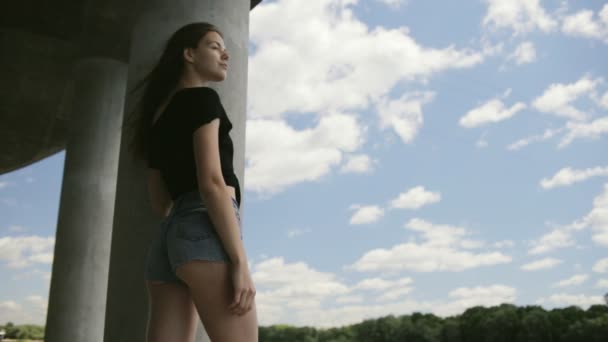 Jeune jolie femme debout près de la rivière — Video