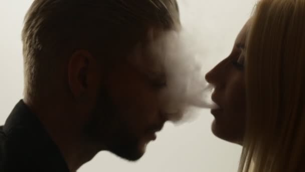 Woman gives smoke kiss to man — Stock Video