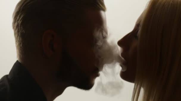 Woman gives smoke kiss to man — Stock Video