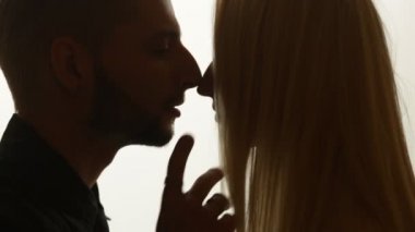 Kadın duman öpücük adama veriyor.