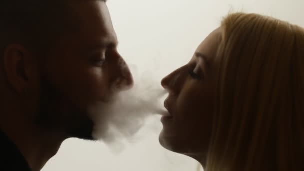 Woman gives smoke kiss to man — Stock Video