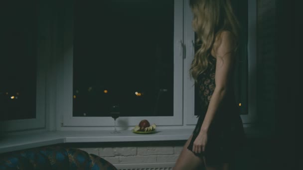 Fit Blond Woman Nightdress Eating Apple Window Indoors Night — Stock Video