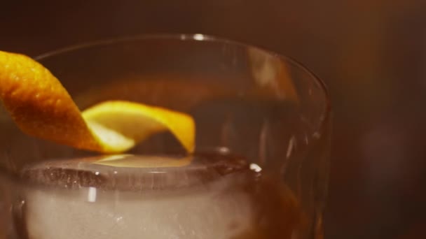 Glass Orange Peel Ice Cocktail Close Slow Motion Shallow Depth — Stock Video