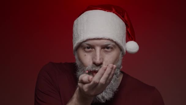 Portrait Santa Claus Making Expressions Red Background Blowing Red Glitter — Stock Video