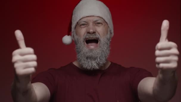 Portrait Santa Claus Making Expressions Red Background Shows Sign Both — Stock Video