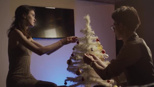 Young Man Woman Decorating Christmas Tree Slow Motion — Stock Video