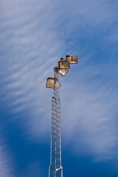 Lonely stadium light or lamp post with Union of light bulb standing alone with cloud and blue sky — Stock Photo, Image