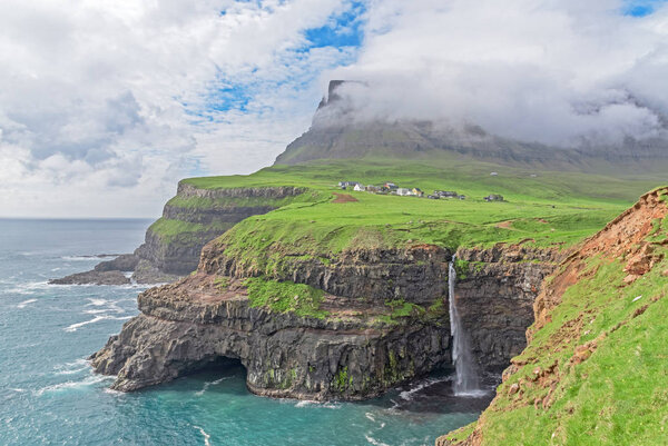 The iconic waterfall of Gasadalur on faroe islands and the remot