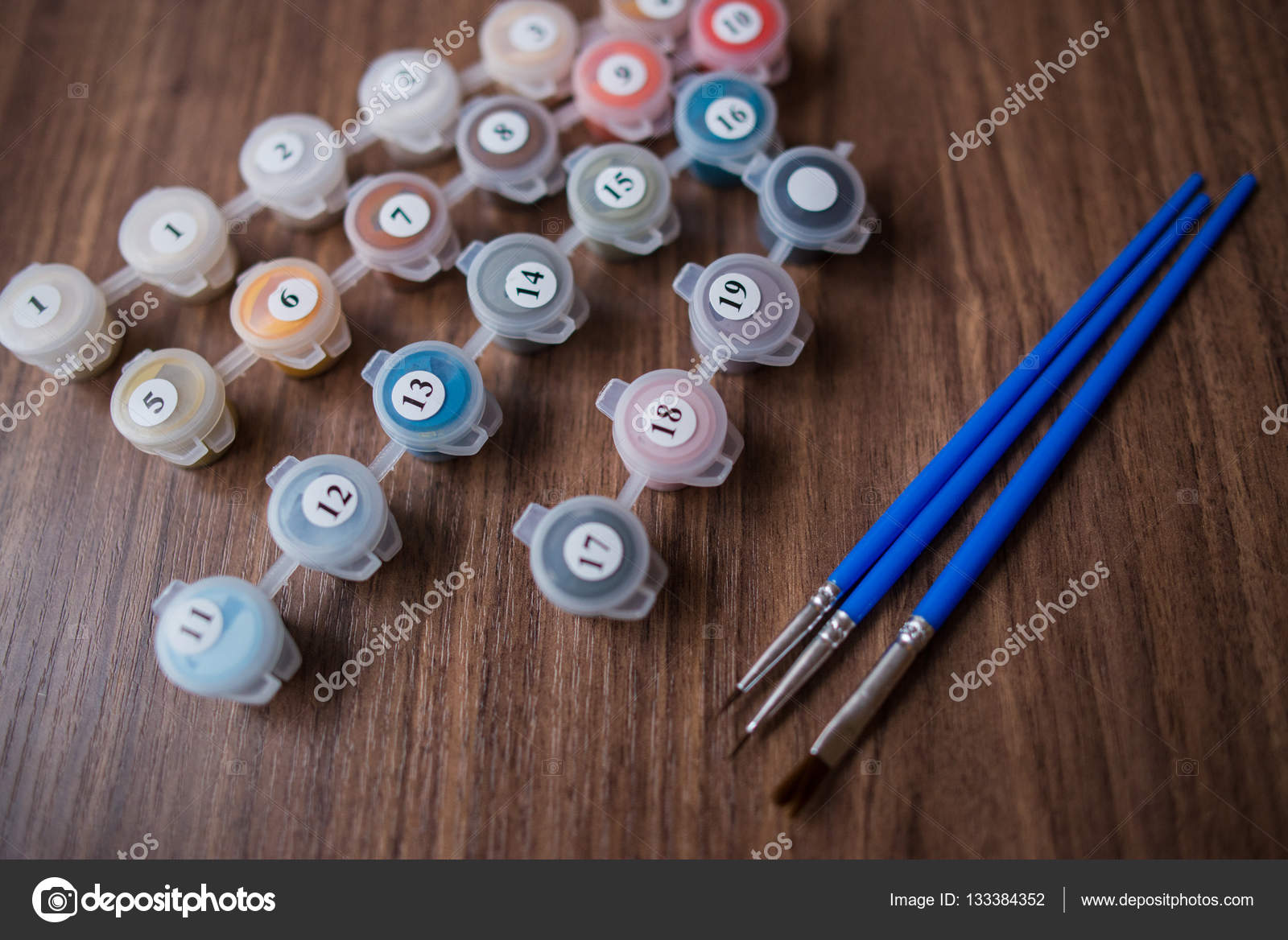 Acrylic paints in small paint buckets with paint brushes aside — Stock