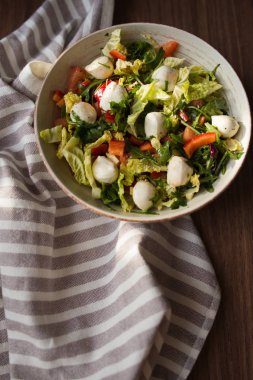 Mozzarella peyniri, yeşillik ve masanın üzerine kırmızı biber salatası