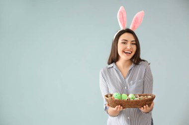 Paskalya yumurtaları ve tavşan kulakları renk arka plan üzerinde olan güzel kadın