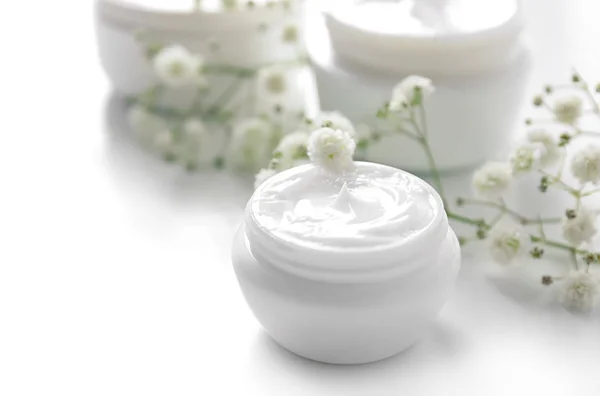 Jar with cream and flowers on white background. Skin care cosmetics — Stock Photo, Image