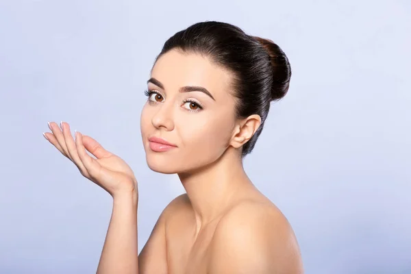 Beautiful young woman with silky skin after spa treatment on light background — Stock Photo, Image