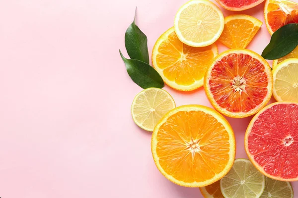 Composition with cut citrus fruits on color background, top view — Stock Photo, Image