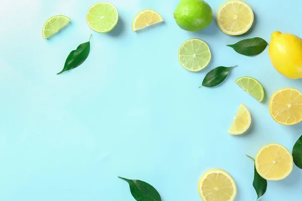 Composition with cut citrus fruits on color background, top view