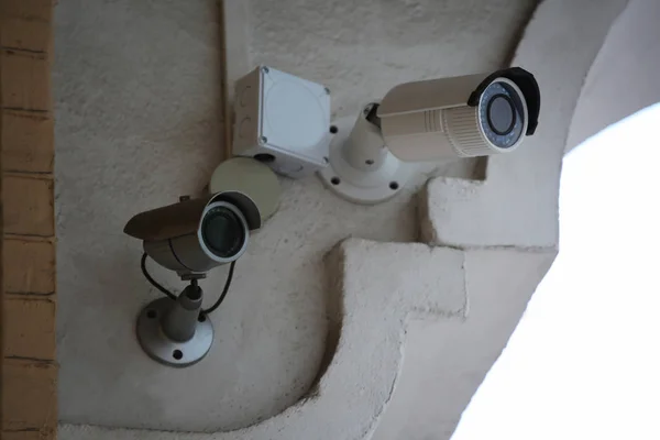 Modern CCTV cameras on wall of building outdoors — Stock Photo, Image