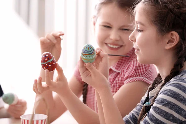 Cute little girls painting eggs for Easter at home — Stock Photo, Image