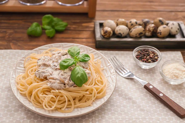 Plate of delicious pasta with mushroom sauce on table — Stock Photo, Image