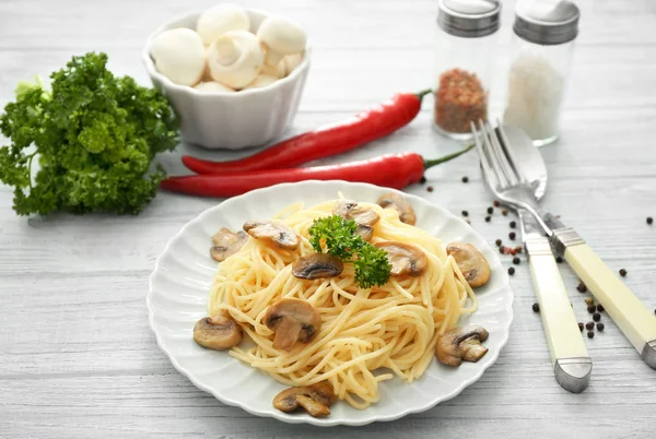 Plate of delicious pasta with mushrooms on table — Stock Photo, Image
