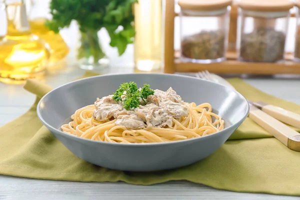 Plate of delicious pasta with mushroom sauce on table — Stock Photo, Image