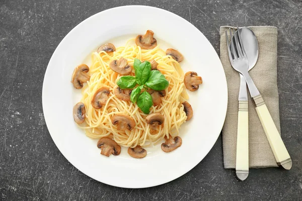 Plate of delicious pasta with mushrooms on table — Stock Photo, Image