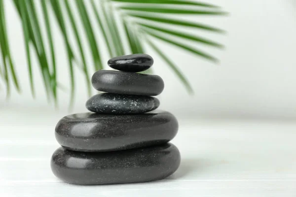 Stack of spa stones on white table — Stock Photo, Image