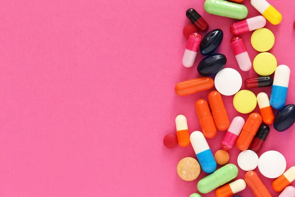 Différentes pilules sur fond de couleur — Photo