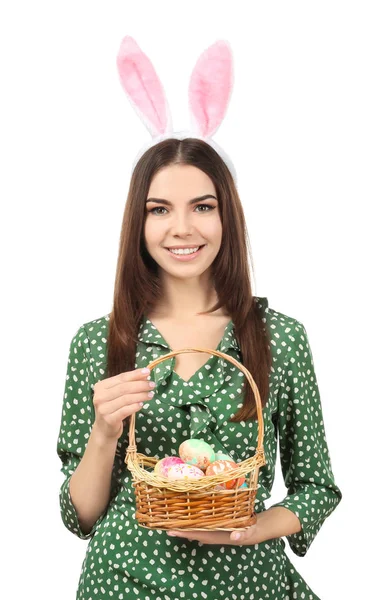 Красива молода жінка з великодніми яйцями і вухами кролика на білому тлі — стокове фото