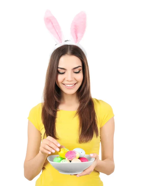 Beautiful young woman with Easter eggs and bunny ears on white background — Stock Photo, Image