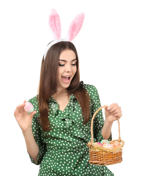 Beautiful young woman with Easter eggs and bunny ears on white background — Stock Photo, Image