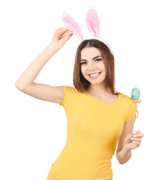 Beautiful young woman with Easter egg and bunny ears on white background — Stock Photo, Image