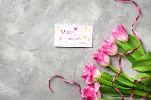 Vackra tulpaner och handgjorda kort för mors dag på grå texturerat bakgrund, ovanifrån — Stockfoto