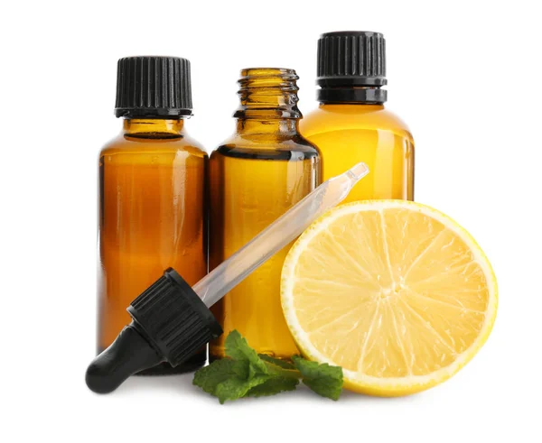 Bottles with lemon and mint essential oils on white background — Stock Photo, Image