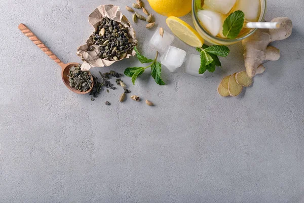 Flat lay composition with glass of cold lemon tea and ginger on table — Stock Photo, Image