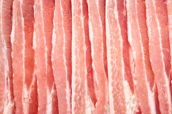 Raw bacon as background, closeup — Stock Photo, Image