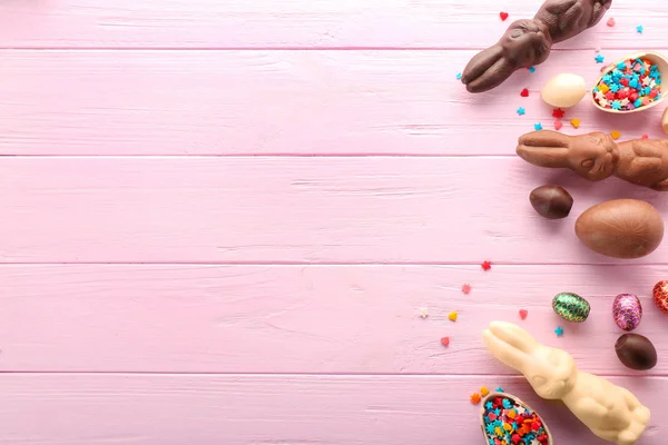 Composición de Pascua con conejitos de chocolate y huevos sobre fondo de madera de color — Foto de Stock