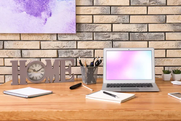 Home workplace with laptop on table — Stock Photo, Image