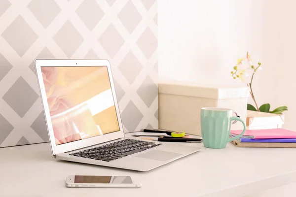 Home workplace with laptop on table — Stock Photo, Image