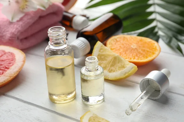 Composition with bottles of citrus essential oils on table — Stock Photo, Image