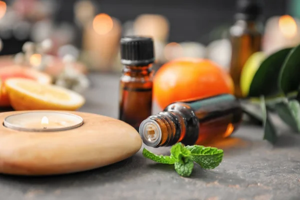 Composition with bottles of citrus essential oil on table — Stock Photo, Image
