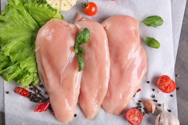 Raw chicken fillet with some ingredients on table — Stock Photo, Image