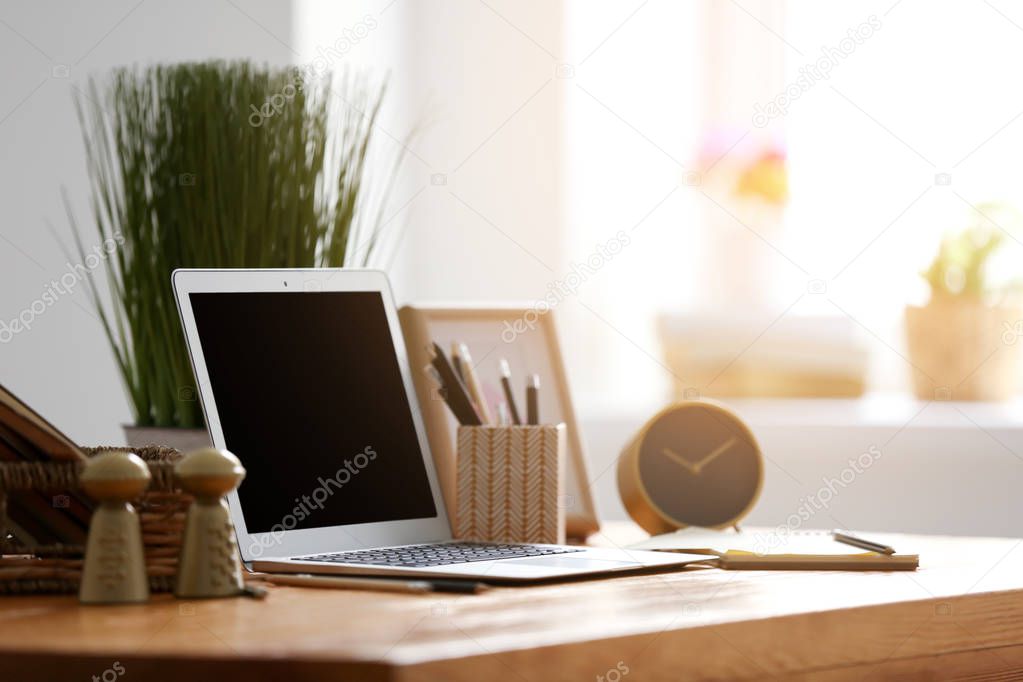 Comfortable home workplace with laptop on table