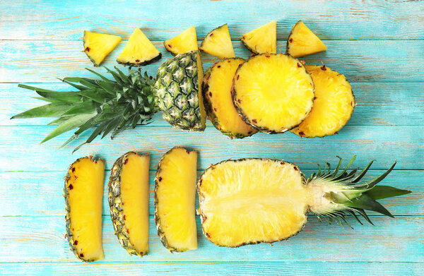 Flat lay composition with pineapple slices on wooden background