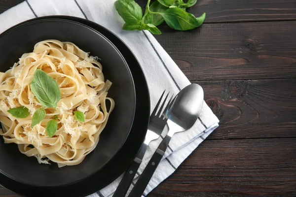 Plate of delicious pasta with cheese on table, top view — Stock Photo, Image