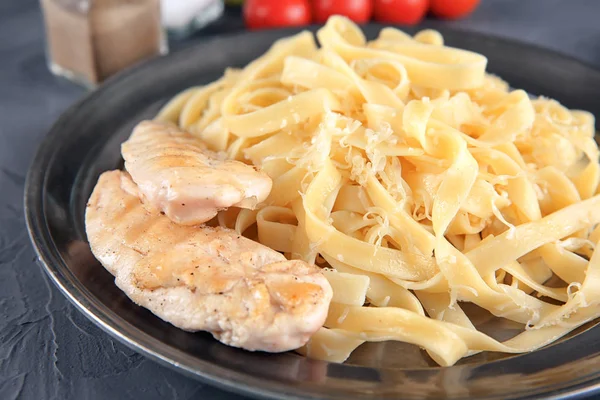 Plate of delicious pasta with cheese and grilled chicken fillet, closeup — Stock Photo, Image