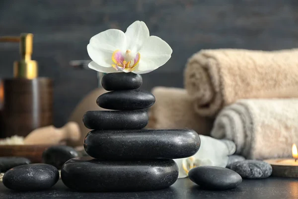 Beautiful spa composition with stones and orchid flower on table — Stock Photo, Image