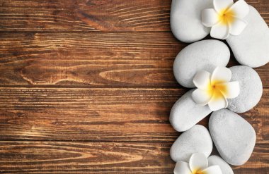 Spa taş ve ahşap zemin üzerine güzel çiçekler