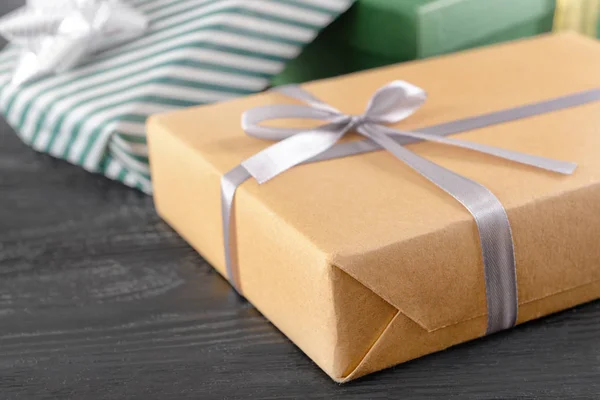 Festive gift box on wooden table, closeup — Stock Photo, Image